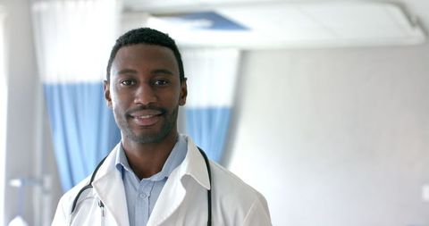 Confident african american doctor smiling in hospital ward