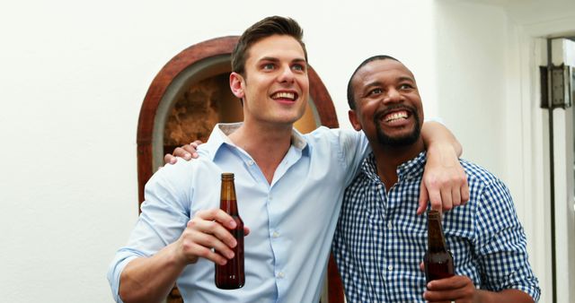 Two happy friends enjoying drinks together indoors - Download Free Stock Images Pikwizard.com