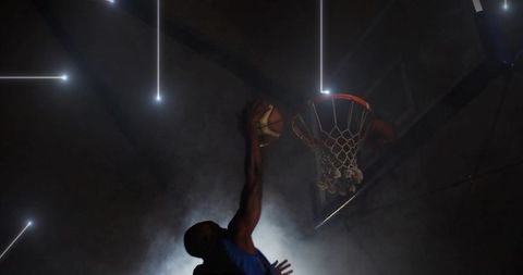 Basketball Player Enacting Powerful Slam Dunk with Dynamic Lighting