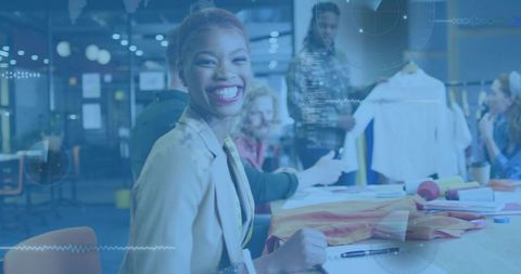 Smiling fashion designer leading studio review with fabric samples and measuring tape