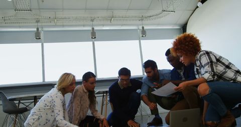 Diverse Team Engaged in Collaborative Brainstorming Session