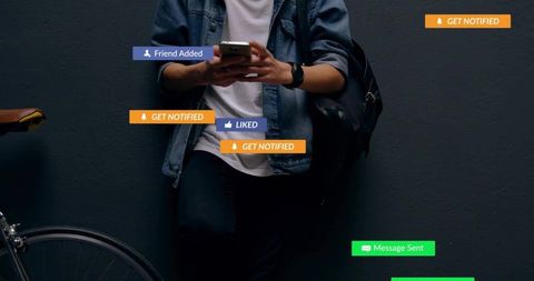 Urban commuter leaning on wall using smartphone with social media notifications