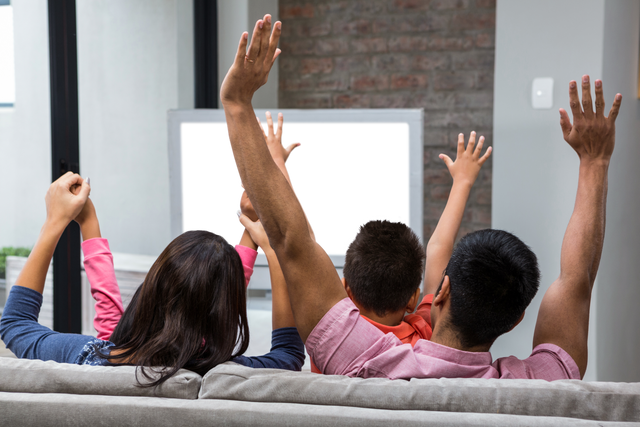 Happy Family Rejoicing on Sofa Watching TV with Transparent Screen - Download Free Stock Videos Pikwizard.com