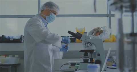 Scientist Conducting Research with Microscope in Laboratory