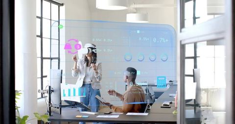 Team collaborating with holographic ar interface in bright modern office