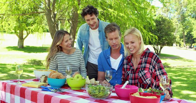 Friends Enjoy Outdoor Barbecue in Lively Park Setting - Download Free Stock Images Pikwizard.com