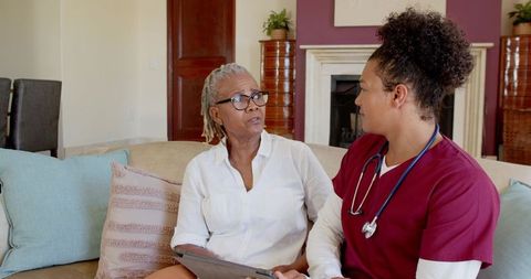 Healthcare Professional Discussing Wellness with Senior Woman at Home
