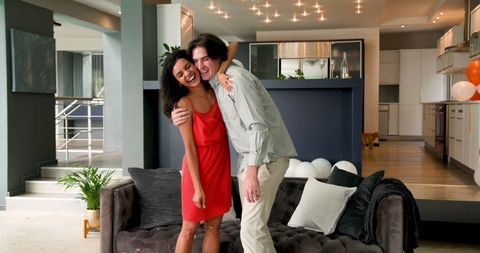 Happy Multiracial Couple Celebrating Anniversary Party at Home