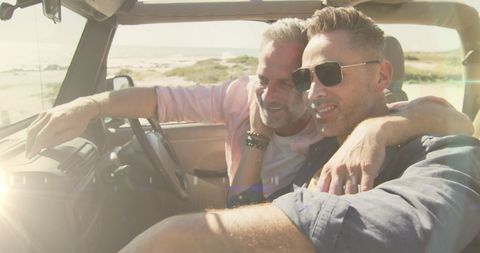 Joyful Gay Couple on Convertible Beach Adventure