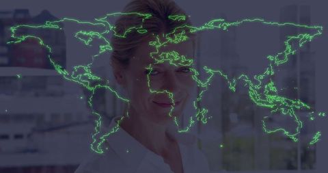 Standing executive woman wearing white blouse showing neon world map overlay in office