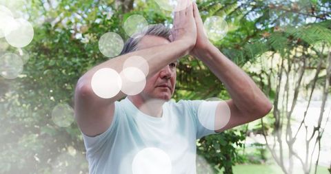 Peaceful Mature Man Practicing Yoga in Garden Serenity