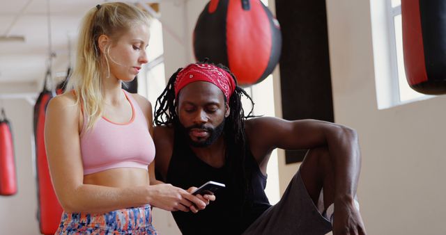 Female Athlete with Coach Reviewing Fitness Data at Gym - Download Free Stock Images Pikwizard.com