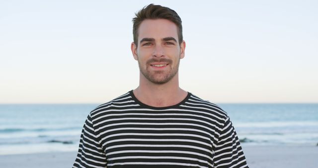 Smiling Man in Striped Shirt at Beach During Sunset - Download Free Stock Images Pikwizard.com