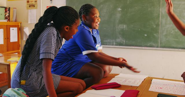 Laughing Schoolgirls Enjoying Group Activity in Classroom Setting - Download Free Stock Images Pikwizard.com