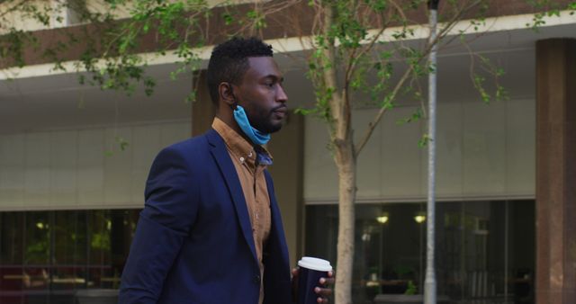 Businessman Holding Coffee Cup While Walking Outdoors - Download Free Stock Images Pikwizard.com