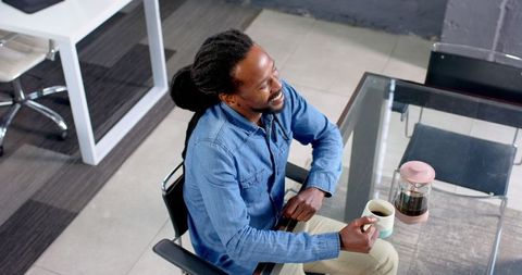 Man Enjoying Coffee Break in Modern Office Setting