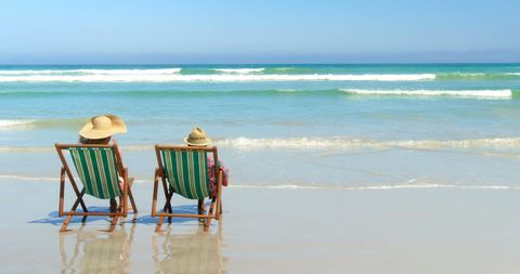 Senior Couple Relaxing on Beach, Enjoying Ocean Views - Download Free Stock Images Pikwizard.com