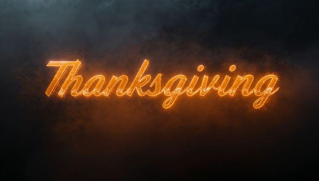 Glowing cursive Thanksgiving sign radiating warm ember light on dark cinematic backdrop