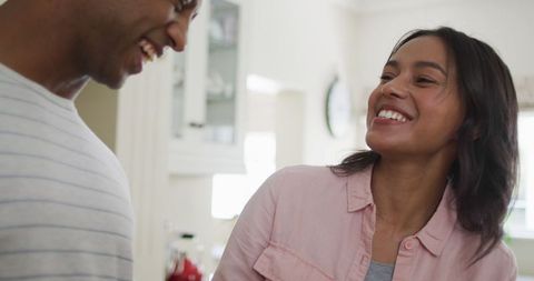 Joyful Biracial Couple Creating Healthy Smoothie in Kitchen