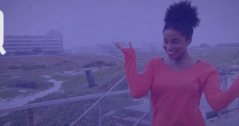 Joyful Woman Raising Arms on Coastal Balcony