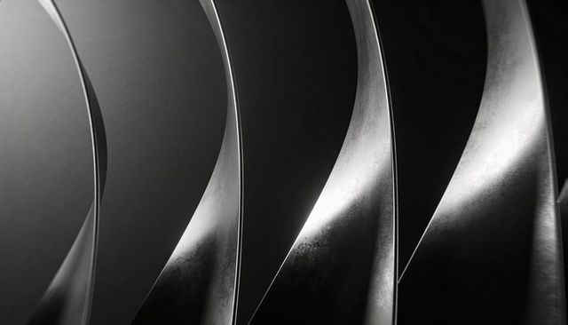 Curving Stainless Steel Vanes Reflecting High-Contrast Studio Light Abstract Metal Texture