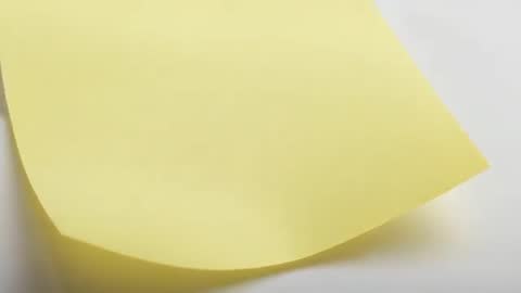 Yellow Sticky Note Uncurling with Adhesive Releasing and Soft Shadow Shrinking — Minimal Closeup Vid