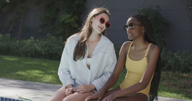 Women Sitting Poolside Relaxing on Sunny Day - Download Free Stock Images Pikwizard.com