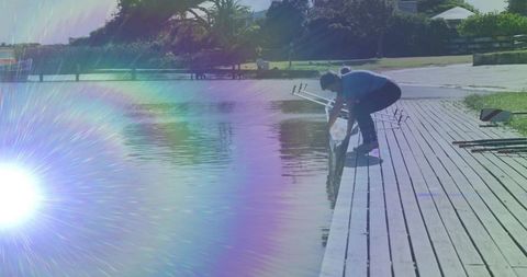 Woman Enjoying Serenity on Wooden Dock by Calm Lake