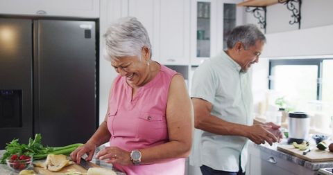 Happy Senior Couple Preparing Healthy Meal in Modern Kitchen