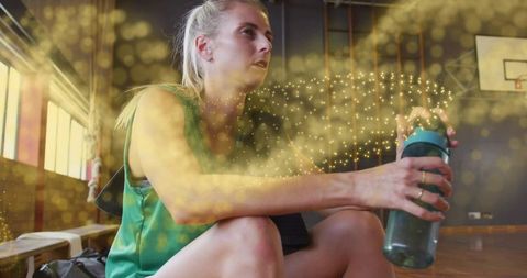 Athlete relaxing in gym with motivational golden light