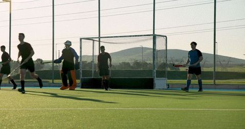 Field Hockey Team Preparing Strategically on Artificial Turf