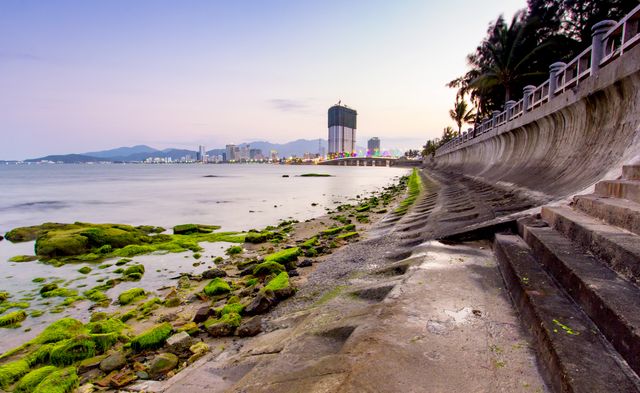 Urban Coastal Landscape with Moss-Covered Rocks and Promenade - Download Free Stock Images Pikwizard.com