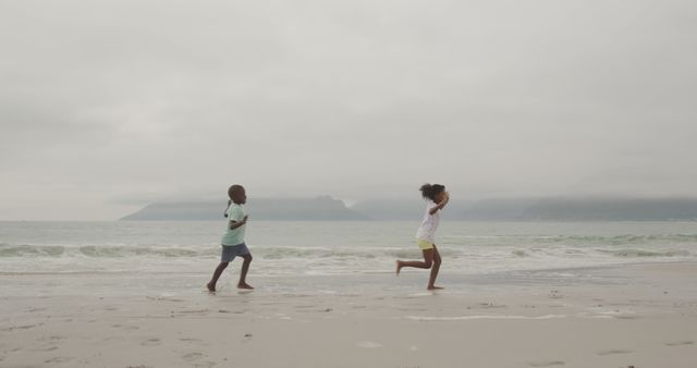 Children Running on Beach with Ocean Background - Download Free Stock Images Pikwizard.com