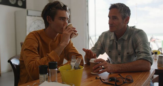 Father and Son Having Coffee Conversation in Causal Setting - Download Free Stock Photos Pikwizard.com