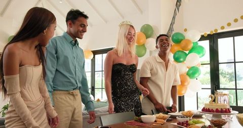 Diverse Friends Celebrating Birthday Party in Bright Living Room