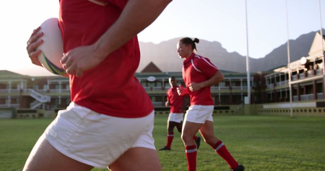 Rugby Players Practicing on Field with Sun Setting - Download Free Stock Images Pikwizard.com