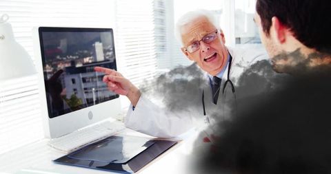 Senior doctor explaining medical scan to male patient