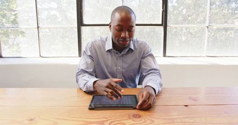 Businessman Using Tablet for Productivity at Work Desk