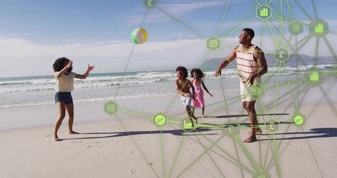 Family playing with beach ball on sunny shore with digital network overlay and tech icons
