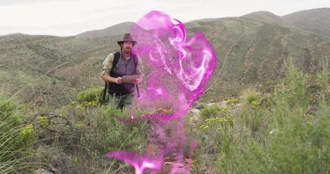 Explorer holding map encountering magenta energy swirl in scrubland on arid mountain ridge