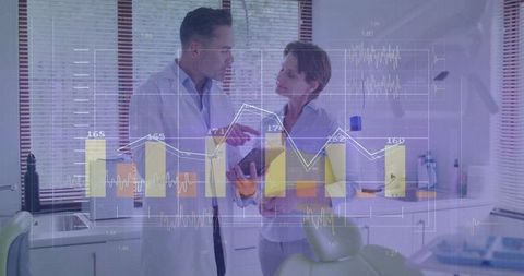 Dentists Reviewing Data on Tablet in Modern Dental Clinic