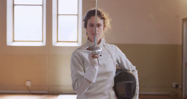 Female Fencer in Protective Gear Holding Sword in Training Room - Download Free Stock Images Pikwizard.com