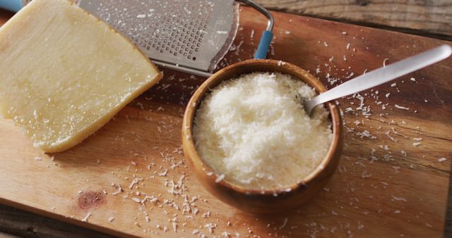 Grated Parmesan Cheese in Bowl with Block and Grater - Download Free Stock Images Pikwizard.com