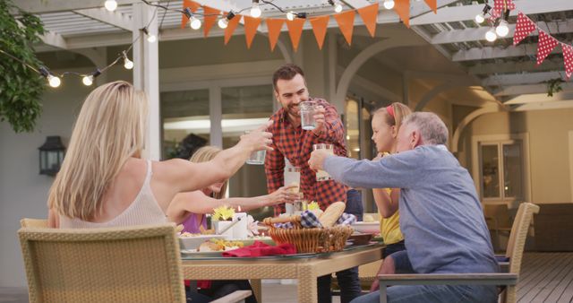 Family Enjoying Outdoor Dinner Together at Festive Patio Table - Download Free Stock Images Pikwizard.com