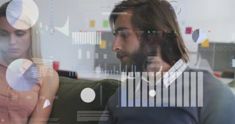 Young Professionals Analyzing Data with Digital Interface in Modern Office