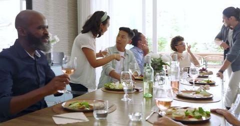 Joyful Gathering Friends Celebrating with Wine at Dinner Party