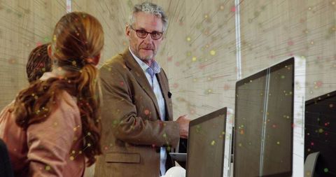Instructor Explaining Data in High-Tech Computer Lab