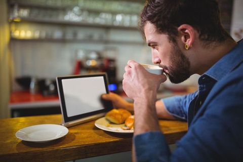 Urban Cafe Workspace with Tablet and Steaming Coffee