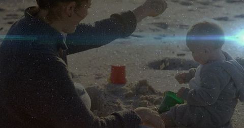 Mother and Child Building Sandcastles on Sunny Beach