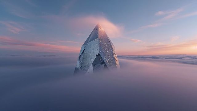 Faceted crystal monolith rising through misty clouds at sunrise with dew-lit surfaces